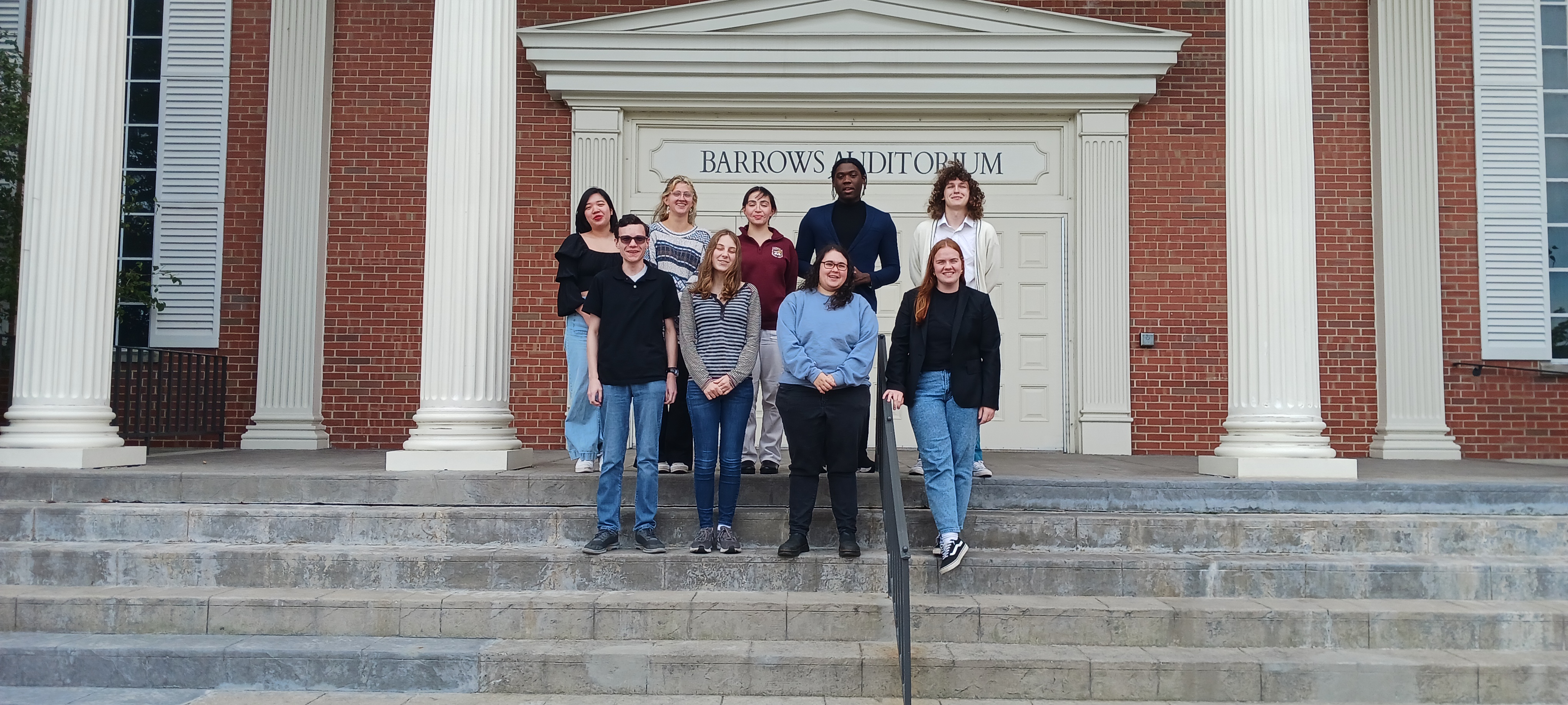 Students from Loyola Chicago's Debate Society outside of a building at Wheaton College in fall 2024